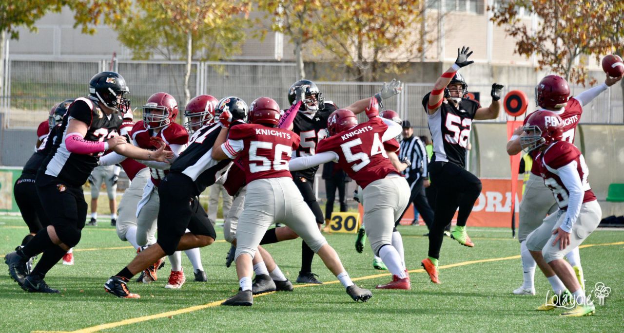 Black Demons Jr. Las Rozas (blanco y negro) vs Royal Oaks Knights Jr. Alcobendas (rojo y blanco).