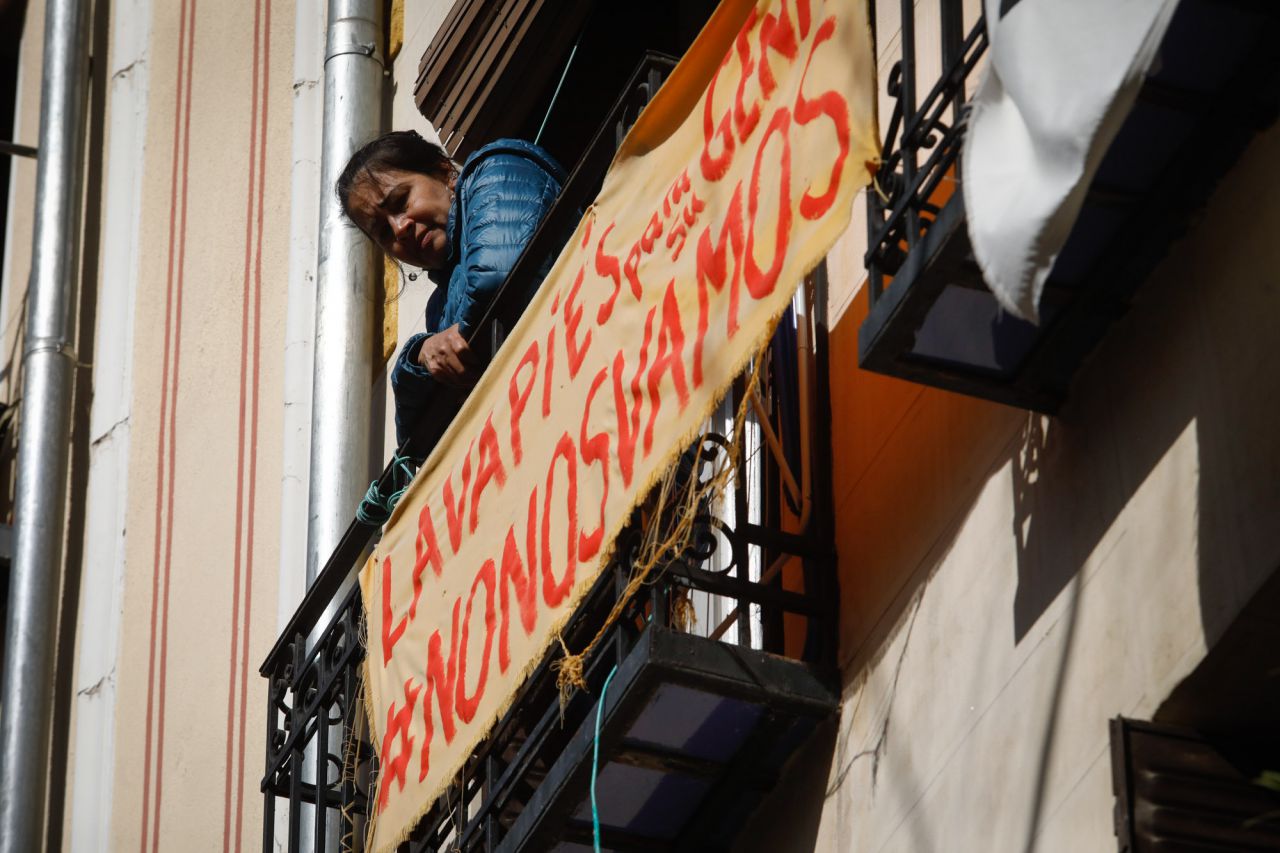 Una vecina de Argumosa 11 observa como los medios de comunicación rodean a las desahuciadas tras tener que abandonar sus hogares.