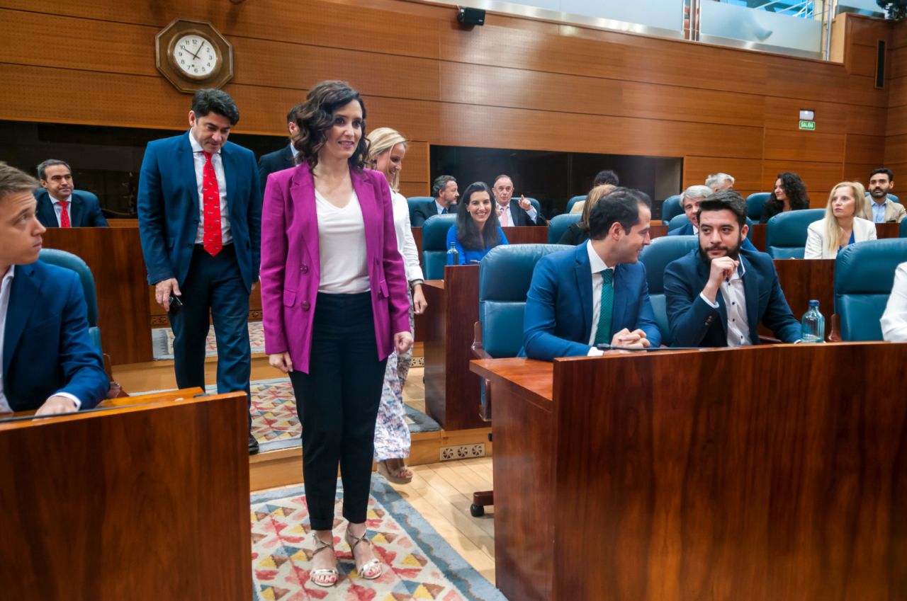 Isabel Díaz Ayuso, a su llegada a la Asamblea, donde Ignacio Aguado intercambia comentarios con su número dos, César Zafra.