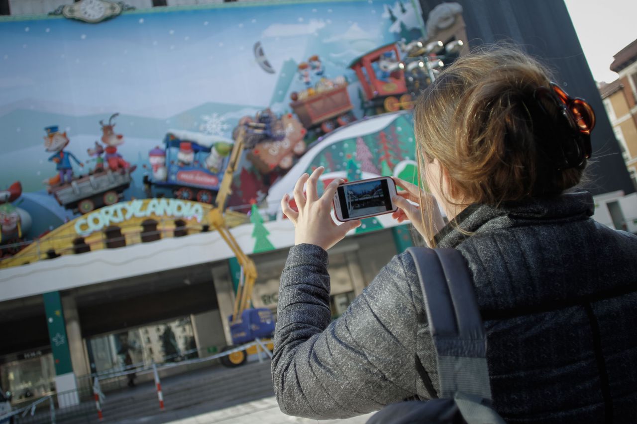 Una viandante hace una fotografía mientras se instala el Cortilandia en la plaza de Celenque.