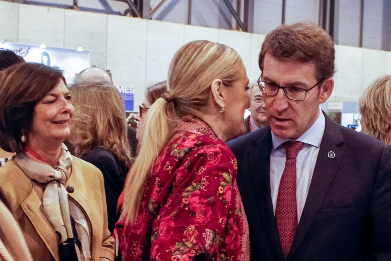 Cristina Cifuentes le dice una cosa al oido a Alberto Núñez Feijoo bajo la atenta mirada de Paloma Adrados.