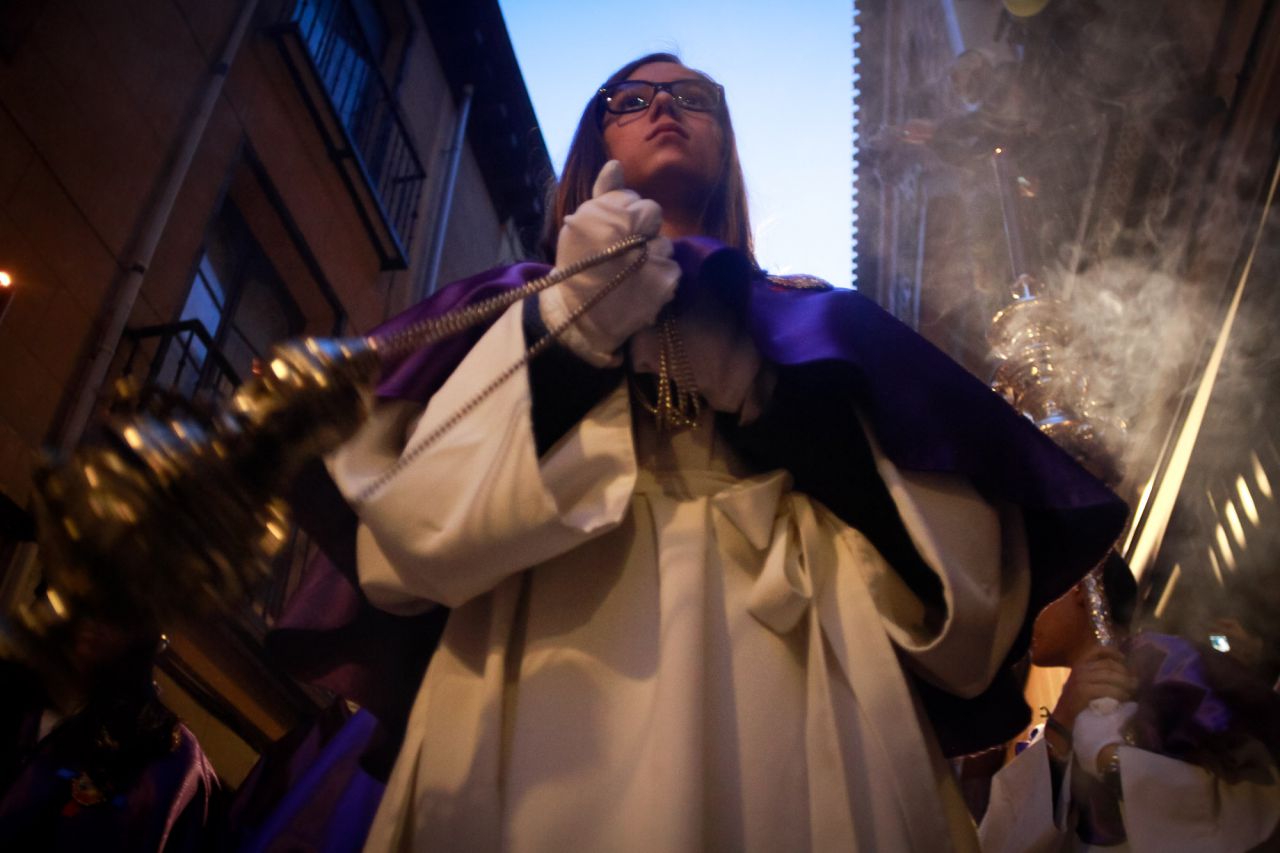 Una hermana cofrade porta el incensario para purificar el paso de Jesús.