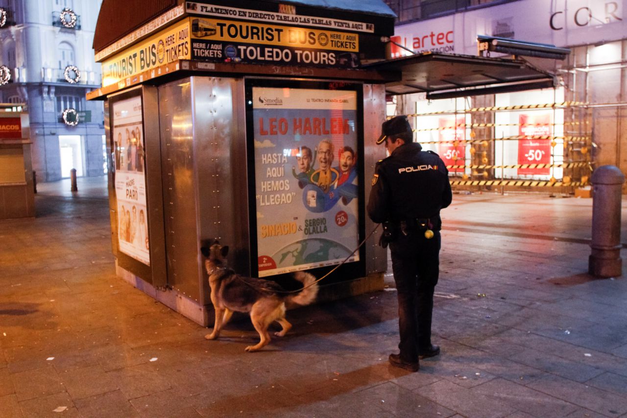 Un agente de la unidad de policía canera inspecciona uno de los kioskos de la plaza de la Puerta del Sol.