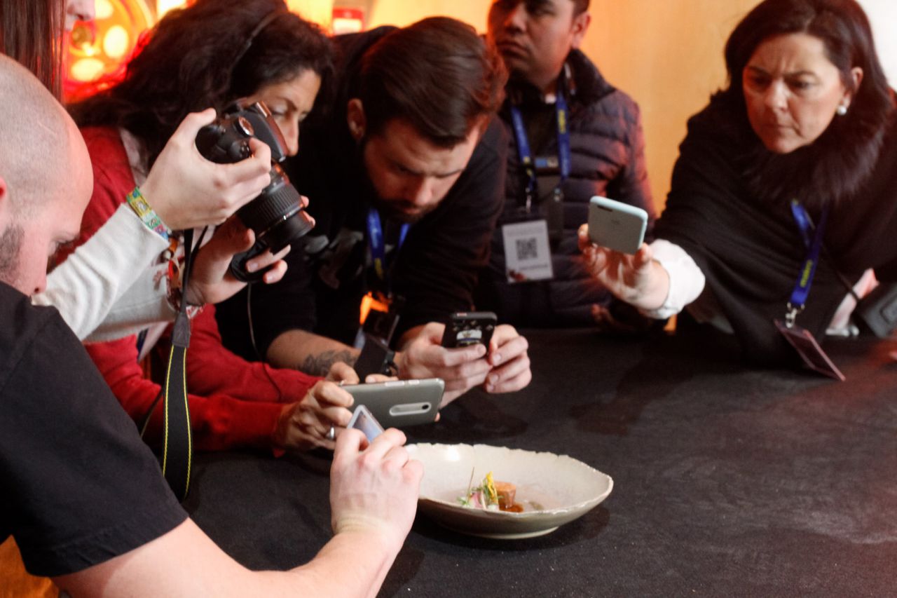 Varias personas aprovechan la 'master class' para fotografiar los platos.