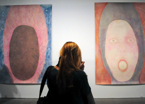 Una mujer observa dos cuadros de la exposición de Elly Strik en el museo Reina Sofía