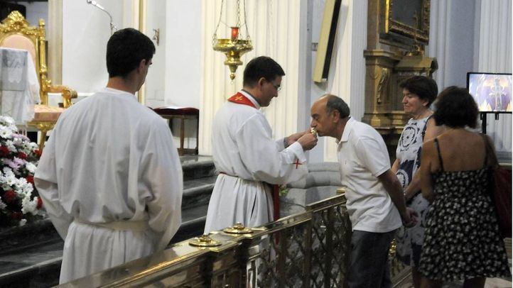 El sacerdote da a besar una reliquia de huesos de San Pantaleón a los fieles.