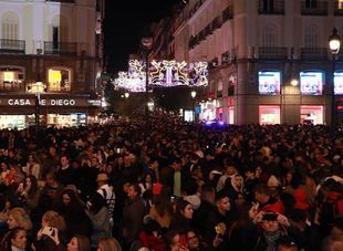 Puerta del Sol llena de gente el día del alumbrado navideño.