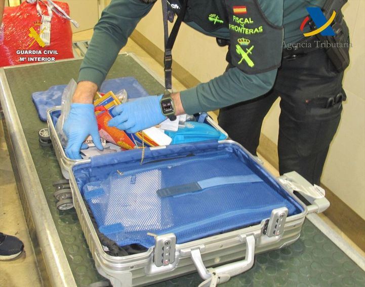 foto de archivo de un agente revisando un equipaje en un aeropuerto