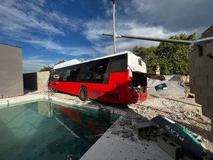 Autobús choca contra muro chalet en Alcalá de Henares