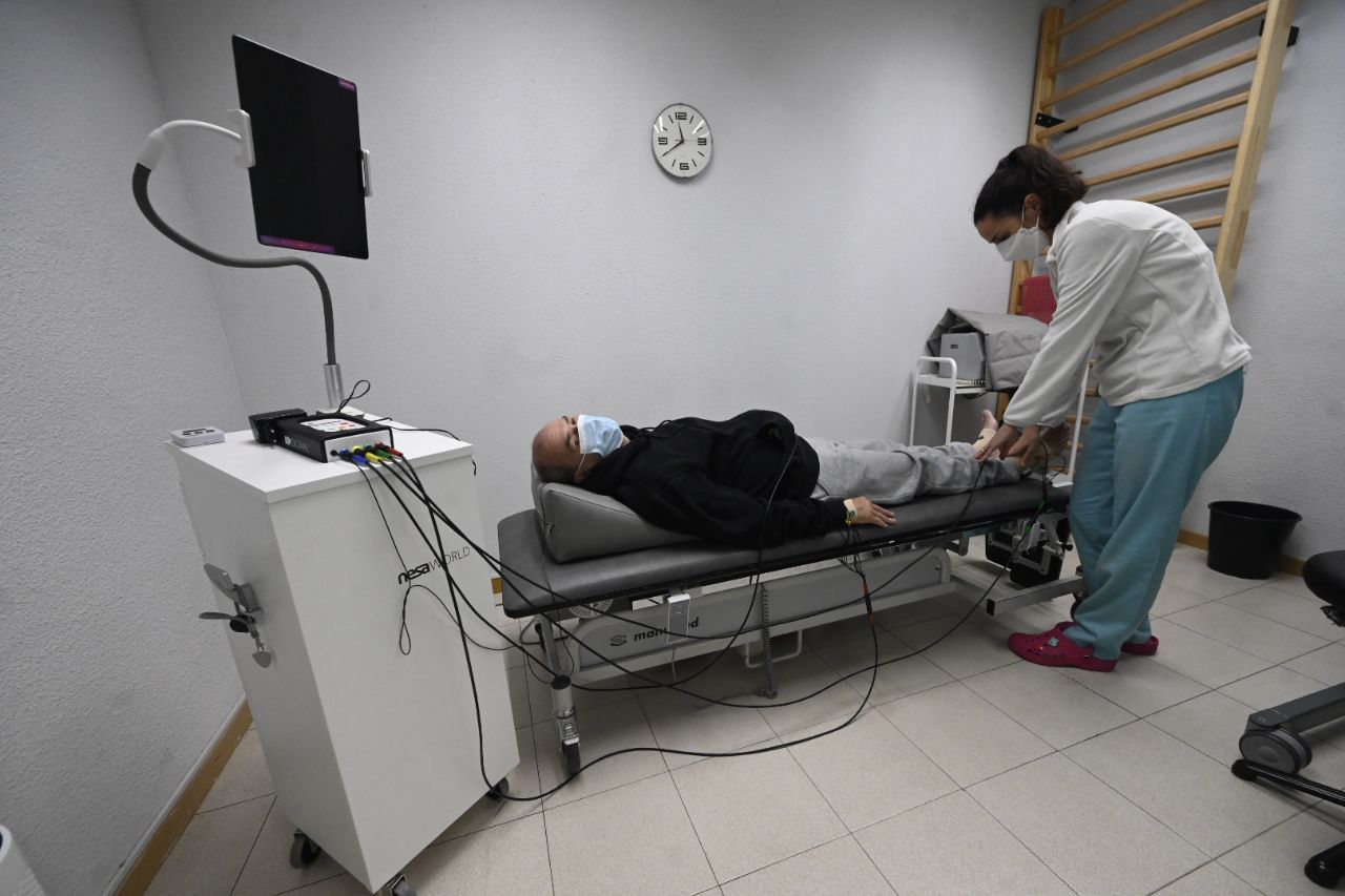 Una fisiterapeuta de la Asociación Mostoleña de Esclerosis Múltiple atiende a Miguel Ángel Llanos en su sesión con Xsignal