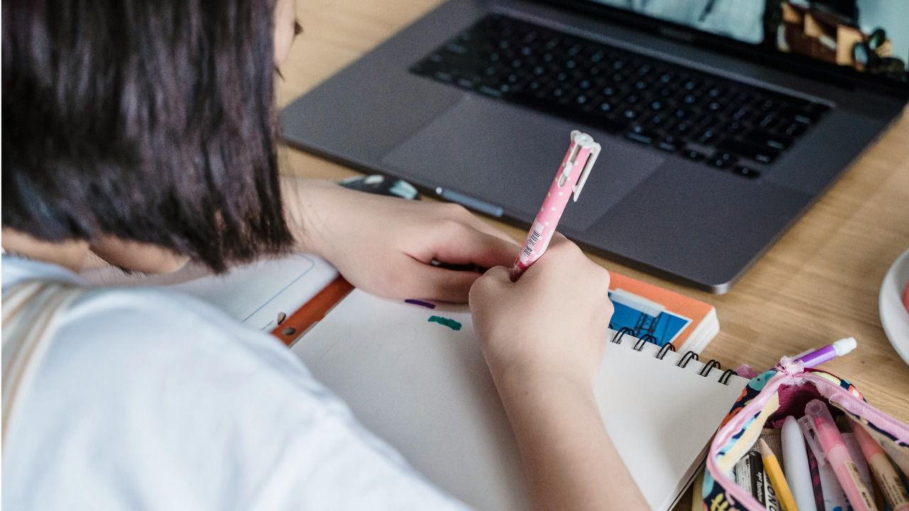 Imagen de una niña utilizando los ordenadores en etapa escolar.